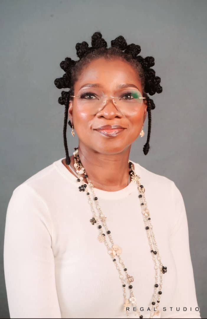 Abimbola Akinkugbe wearing glasses and a necklace